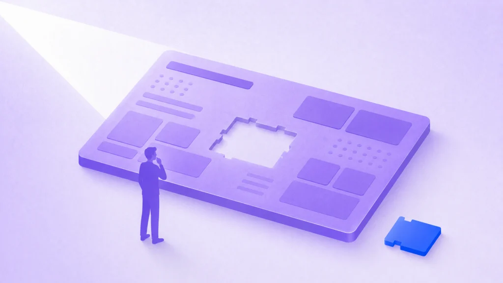 A person studies a large board with one missing piece while the matching blue piece lies nearby.